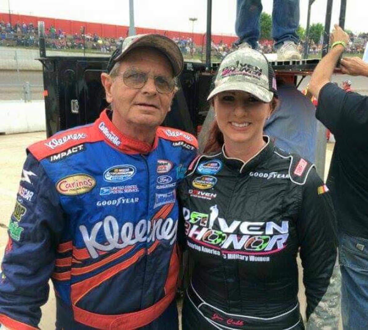 Joe and Jennifer, both in firesuits, at the track.